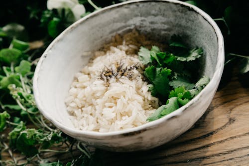 Bowl with cooked white rice and parsley