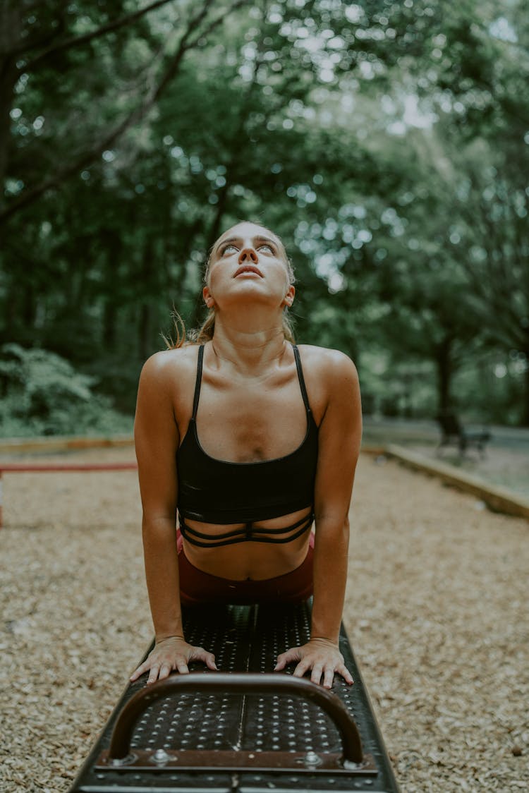 Young Woman Doing Stretch Exercise On Bench