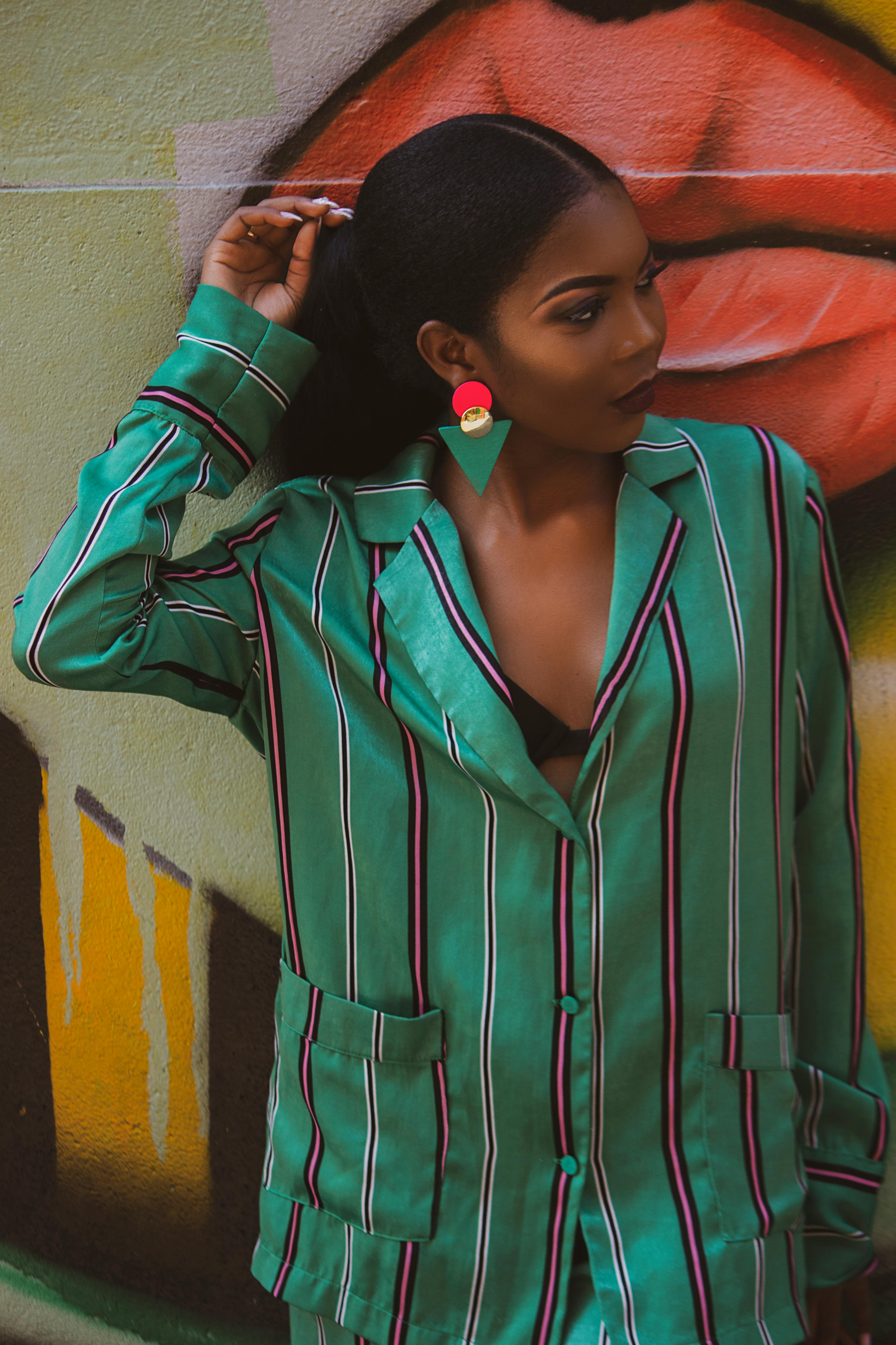 girl in green and black stripe zip up jacket