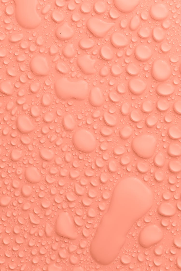 Peach Colored Background With Water Drops