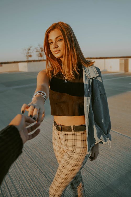 Young woman reaching hand to boyfriend