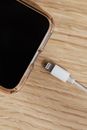 Smartphone and charger usb connector on wooden table