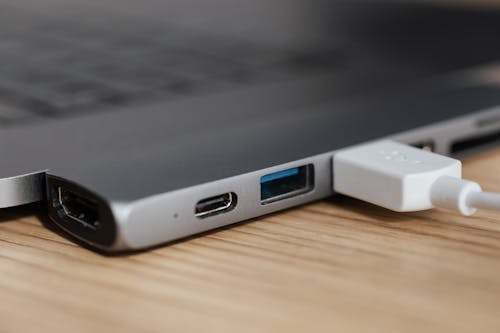Free USB type c multiport adapter with plugged white cable connected to modern laptop Stock Photo