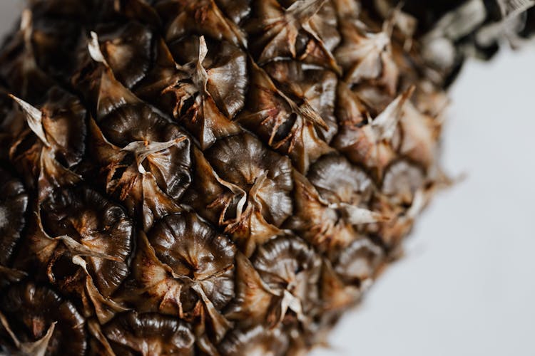 Whole Unpeeled Pineapple On White Background