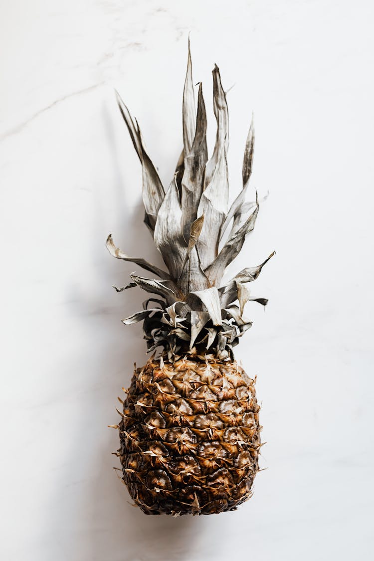 Whole Pineapple On White Marble Surface