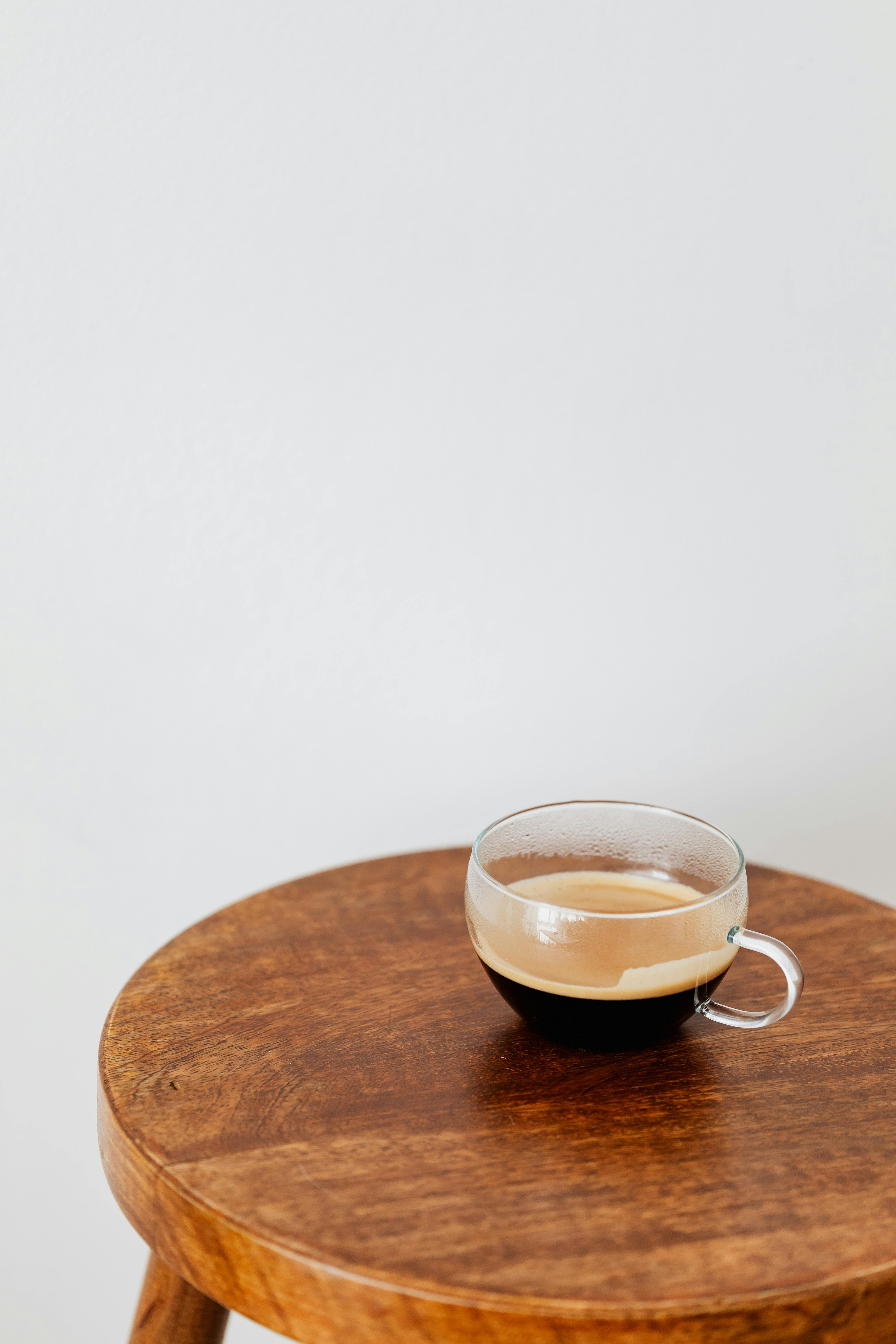 fresh black coffee in wide cup on table