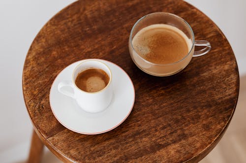 Cups of coffee placed on wooden table