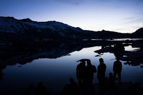 Silhouette of People Near Body of Water