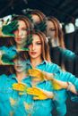Woman in Blue Long Sleeve Shirt With Green Yellow and Blue Paint on Face