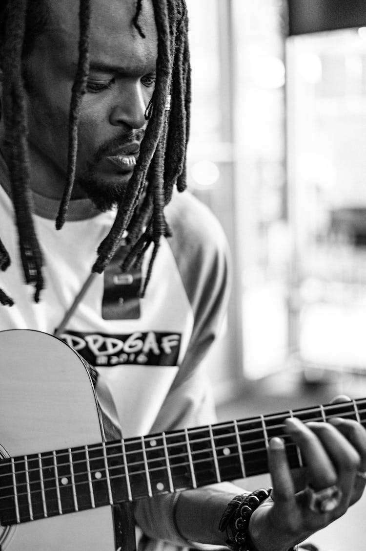 Crop Black Musician With Dreadlocks Playing Guitar