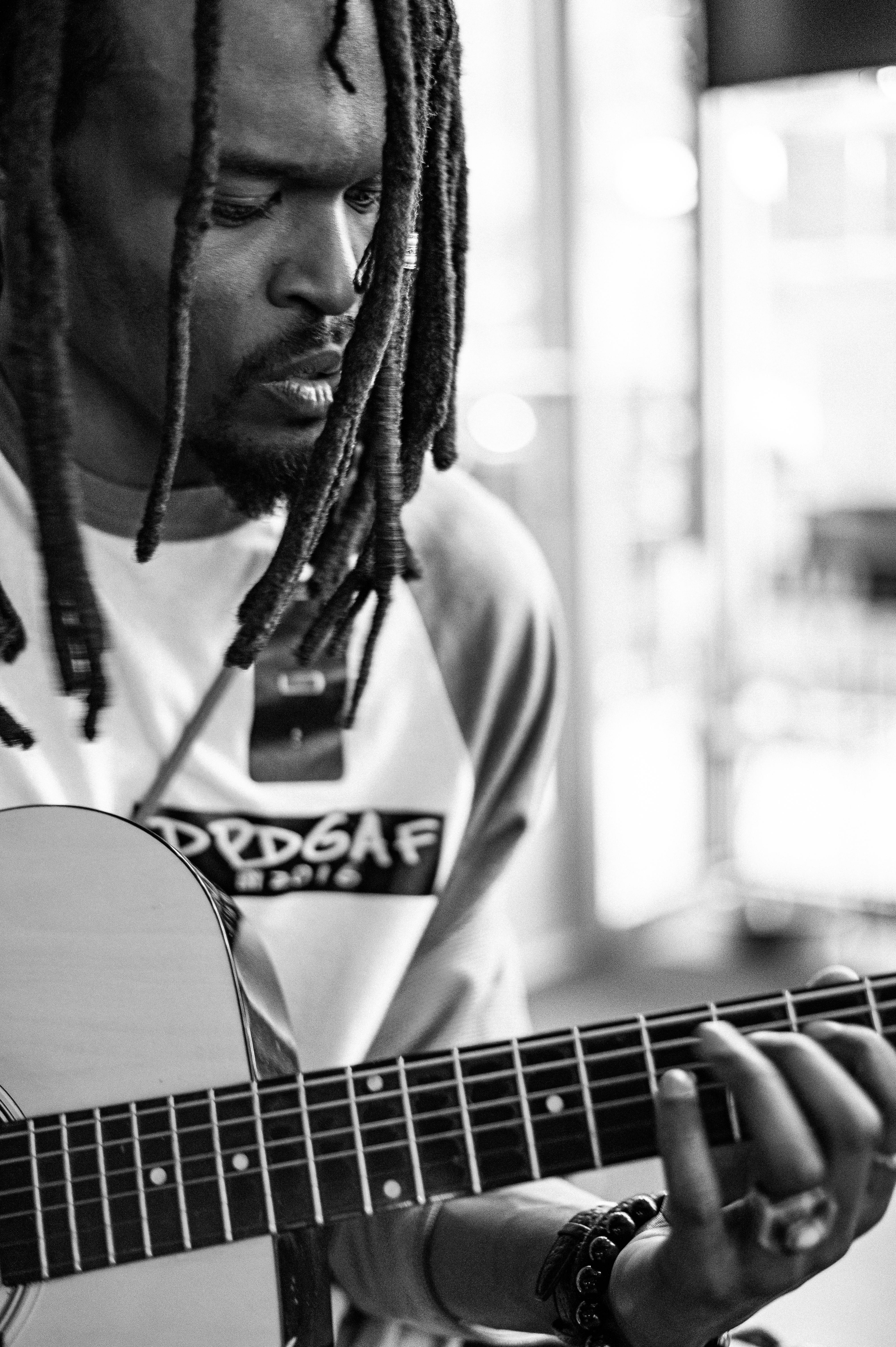 Crop black musician with dreadlocks playing guitar · Free Stock Photo