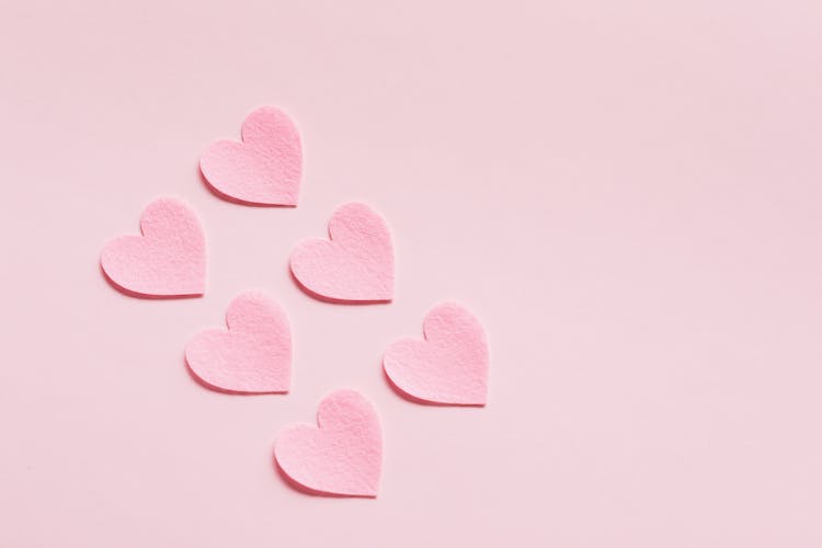 Heart Shaped Papers On Pink Background