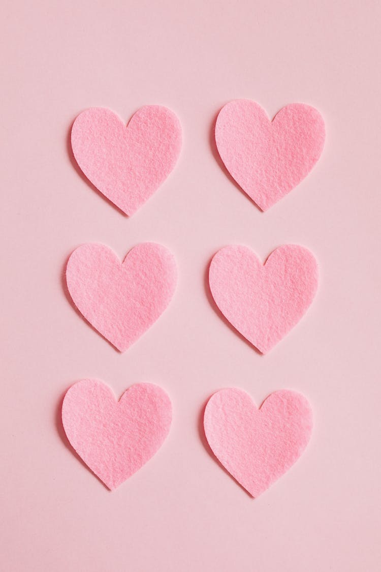 Bright Pink Heart Shaped Cutouts On Pink Background