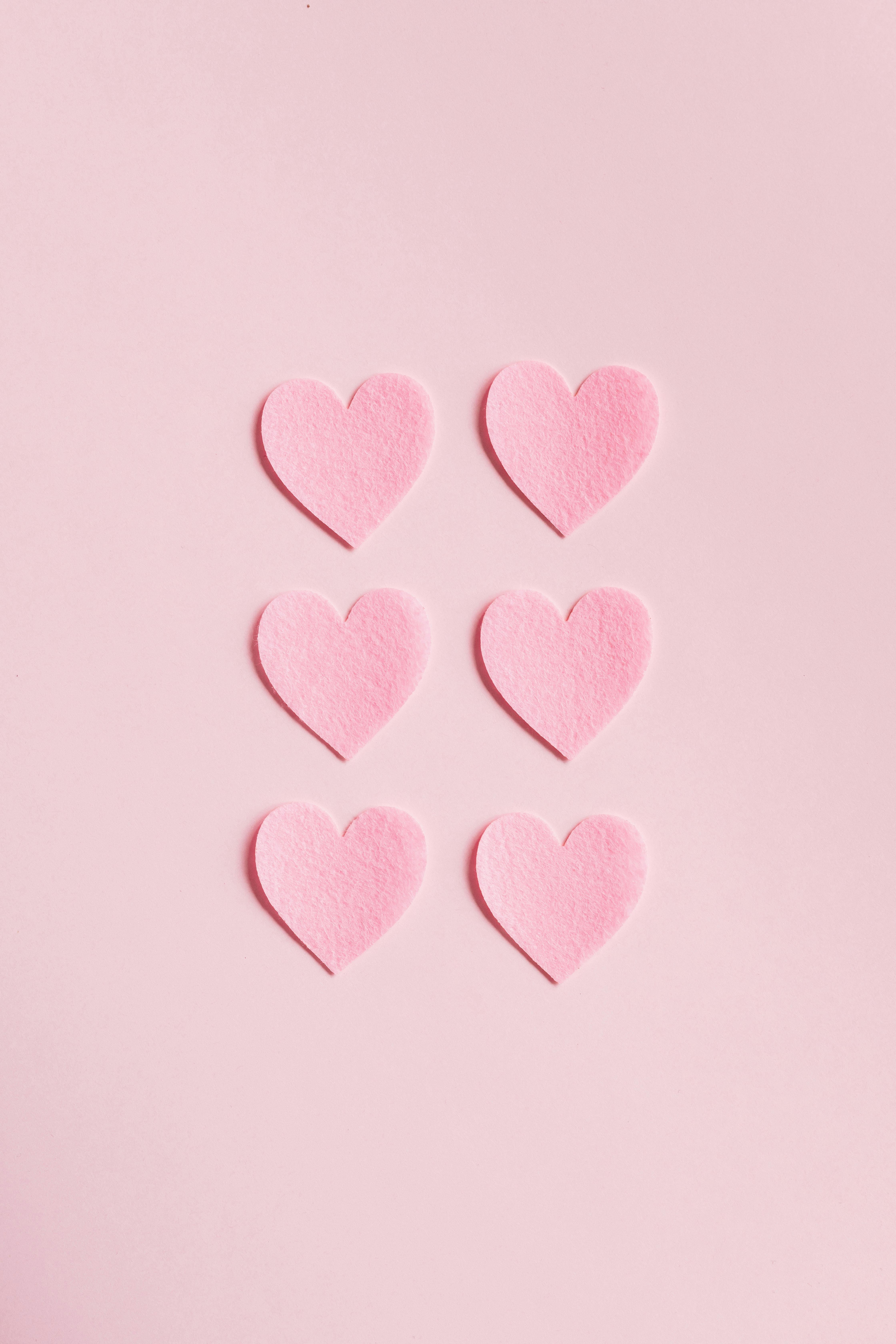 heart shaped cutouts on pink background