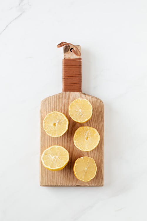 Cutting board with halves of fresh lemons