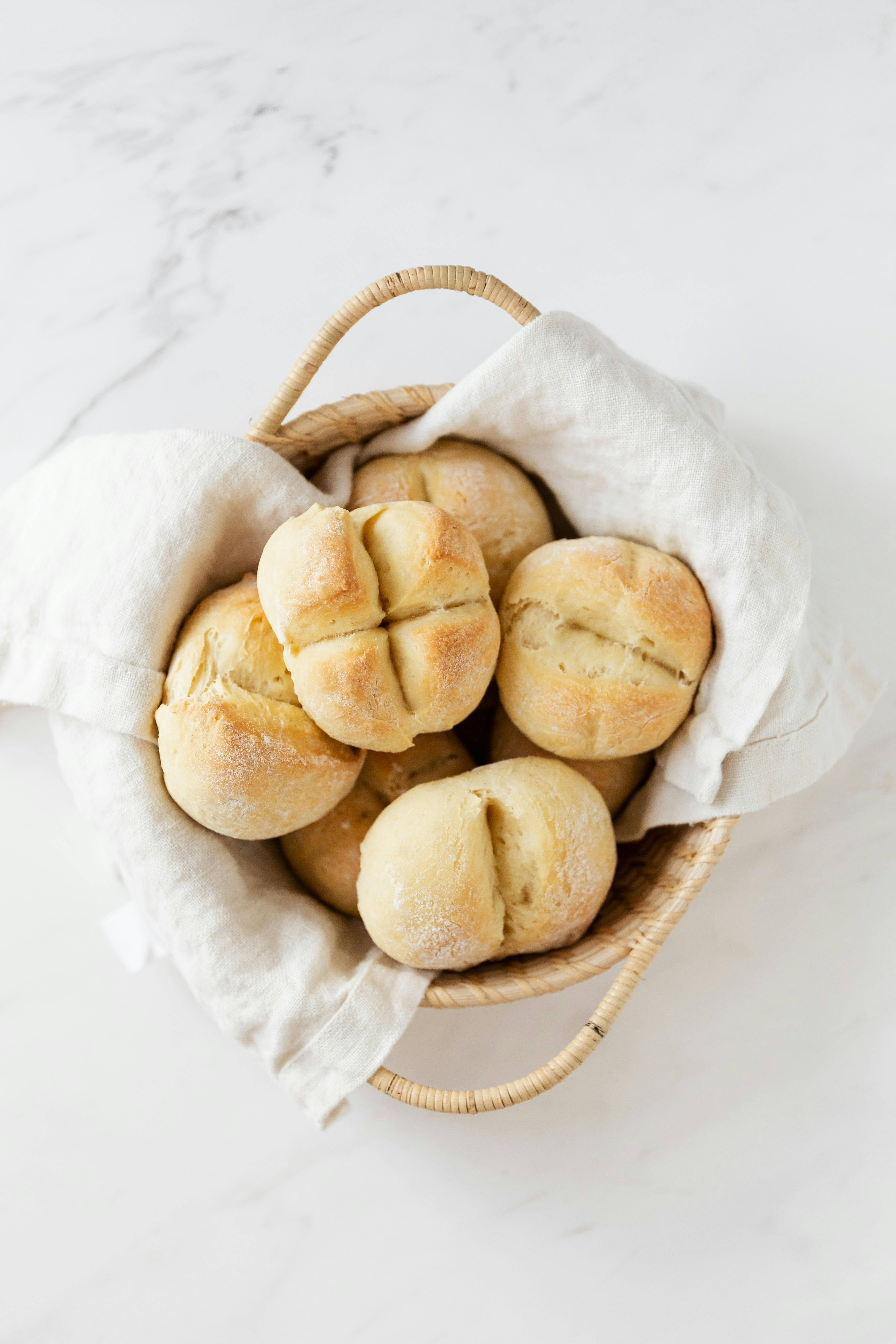 basket with fresh swiss buns on marble table