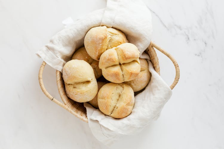 Fresh White Bread Buns In Wicker Basket