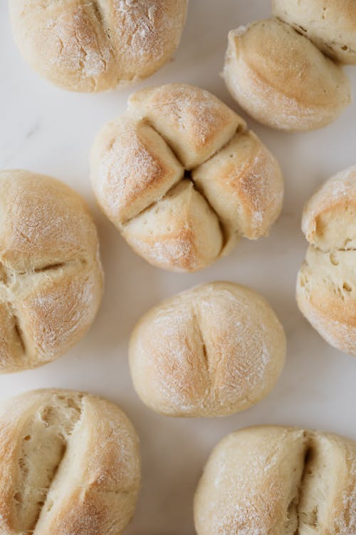 Free Fresh round bread buns on white table Stock Photo