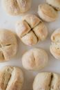 Fresh round bread buns on white table