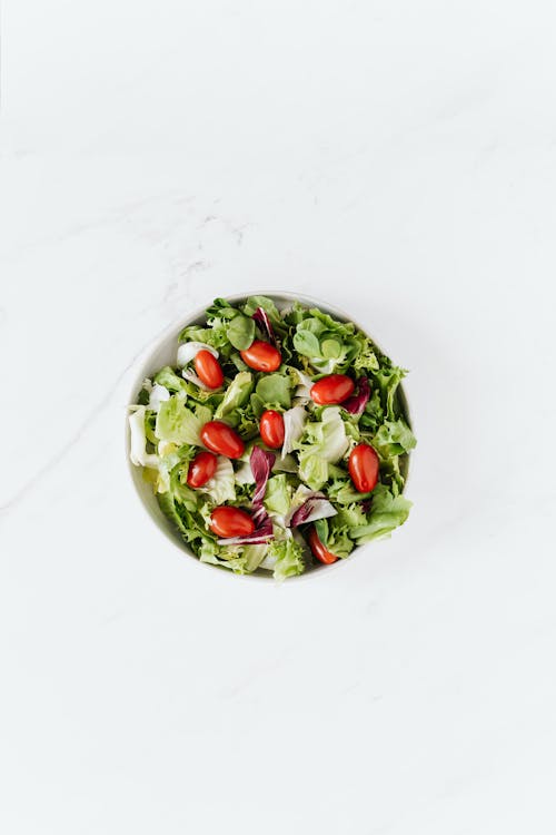 Free Bowl of fresh vegetable salad on table Stock Photo