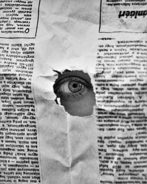 Free Eye on a Hole in a Paper  Stock Photo