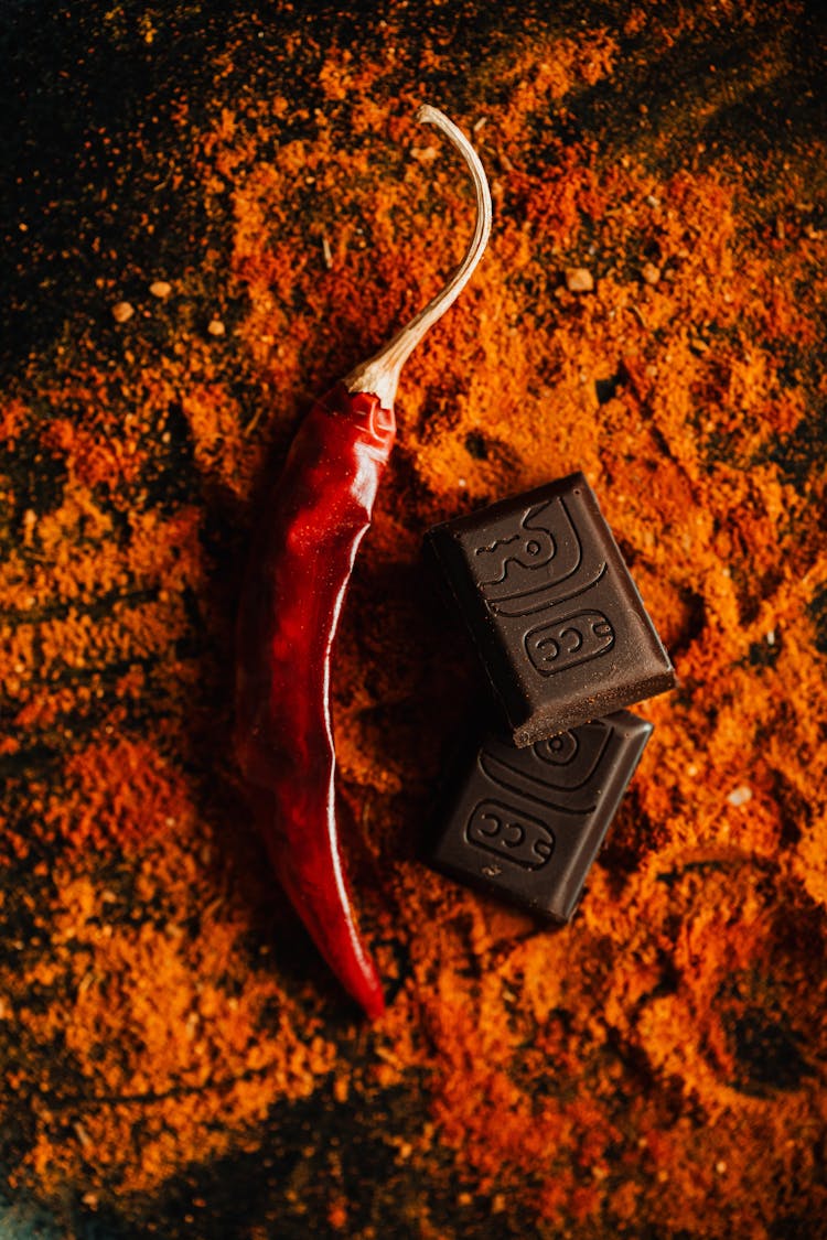 Red Pepper With Chocolate Placed On Table With Spice