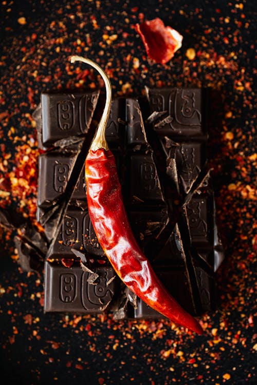 Photo Of Dried Hot Pepper On Top Of Sliced Chocolate Bar