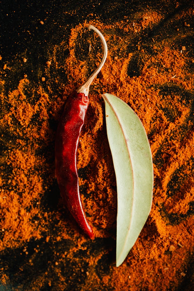 Pepper Pod On Powder Of Ground Spices