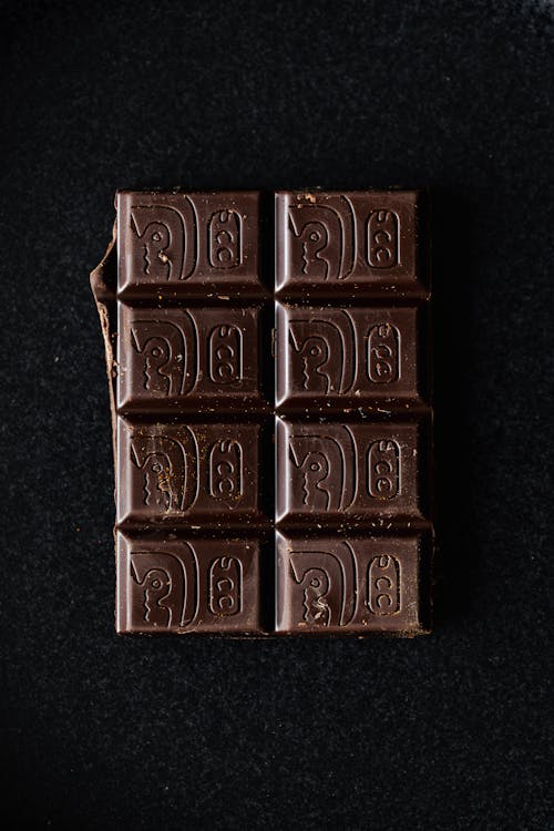 Dark chocolate bar on black surface