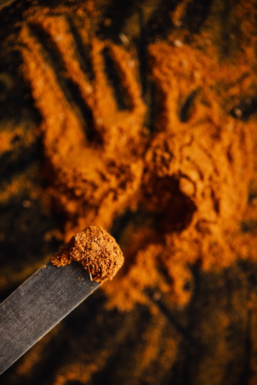 Free Overhead sample of paprika powdered spice taken from heap of ground relish in dark barn Stock Photo