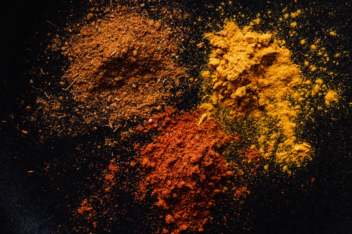 Free Assorted colorful dry powdered spices on black background Stock Photo