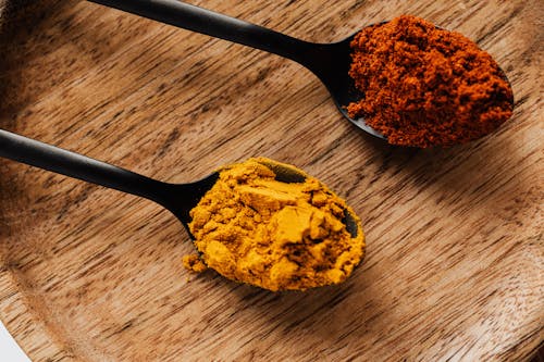 Free Ground turmeric and hot paprika on cutting board Stock Photo