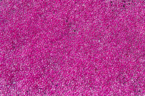 Free Detailed close-up of shiny pink beads creating a textured and vibrant background. Stock Photo