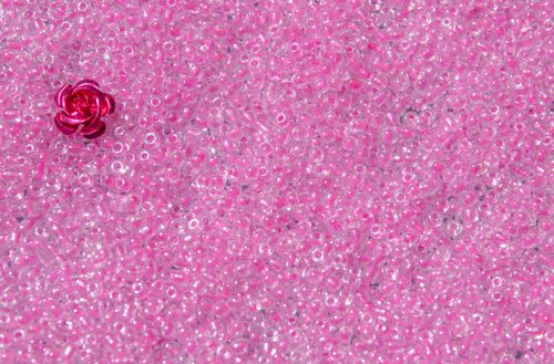 Free A close-up of pink translucent beads with a single rose-shaped bead. Stock Photo