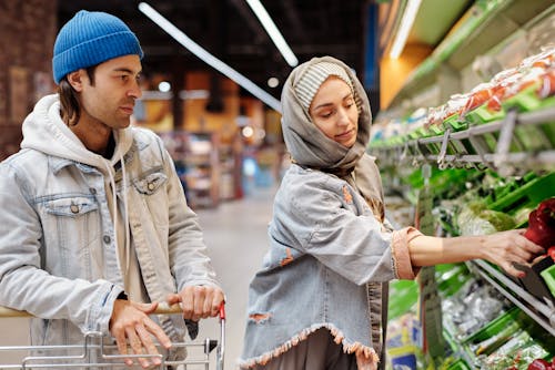 Free Couple Buying Groceries at a Supermarket Stock Photo