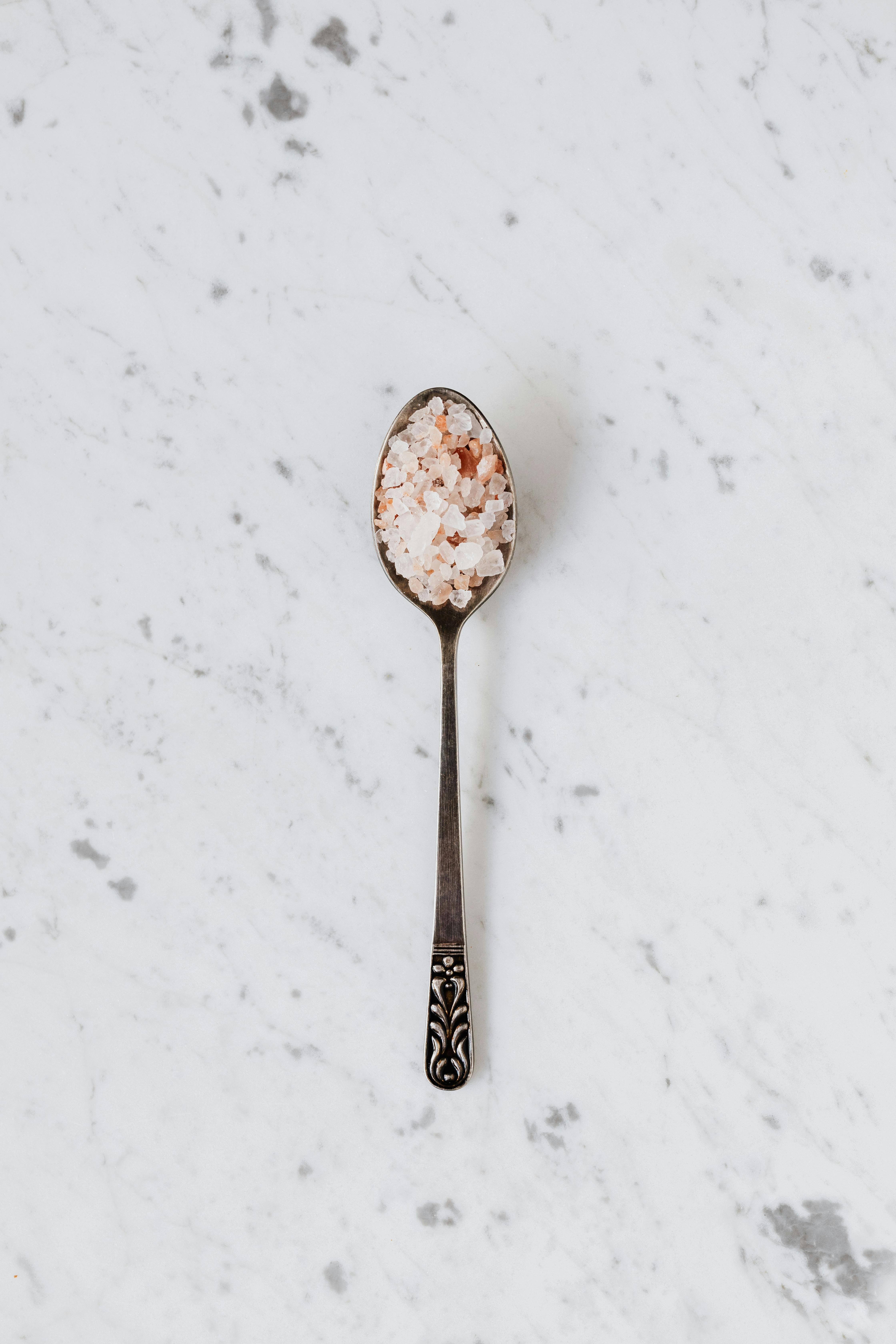 spoon with salt and spices on table