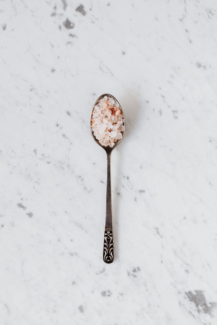 Spoon With Salt And Spices On Table