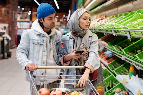 Free Couple Buying Groceries at a Supermarket Stock Photo