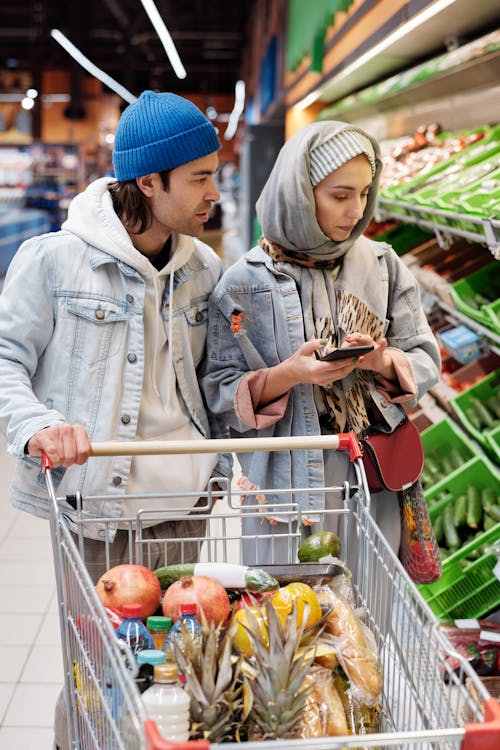 Free Couple Buying Groceries at a Supermarket Stock Photo