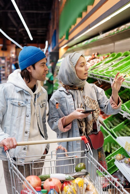 Free Couple Buying Groceries at a Supermarket Stock Photo