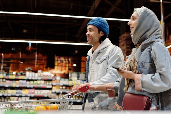Couple with a Shopping Cart Buying Groceries