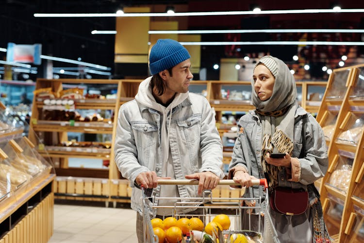 Couple With A Shopping Cart Buying Groceries