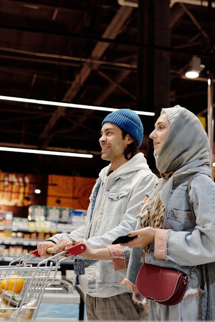 Couple With A Shopping Cart Buying Groceries