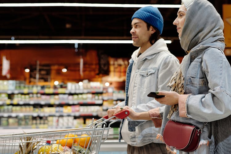 Couple With A Shopping Cart Buying Groceries