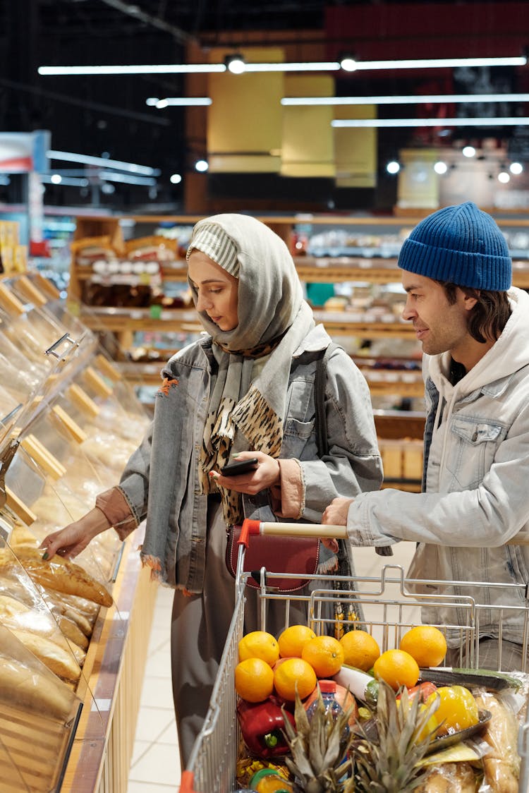 Couple With A Shopping Cart Buying Groceries