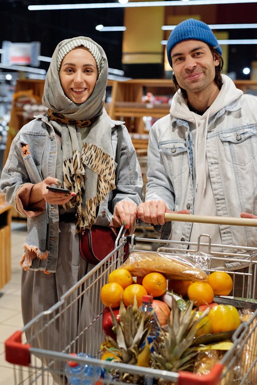 Couple with a Shopping Cart Buying Groceries