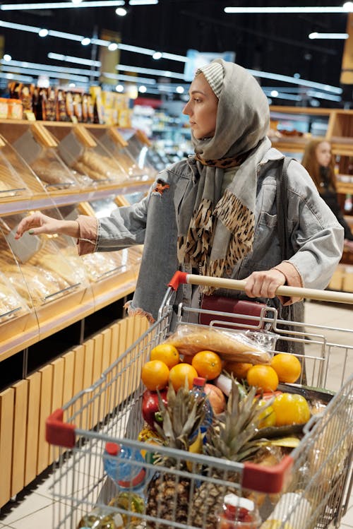 Free Woman in a Hijab Buying Groceries Stock Photo