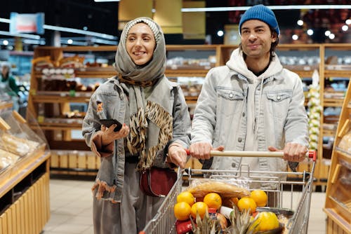 Couple with a Shopping Cart Buying Groceries