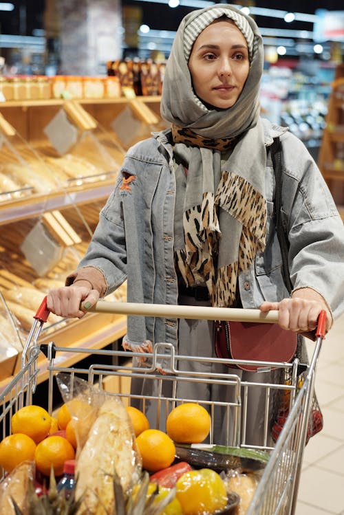 Free Woman in a Hijab Buying Groceries Stock Photo