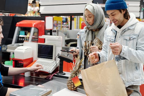 Free Couple Buying Groceries at a Supermarket Stock Photo